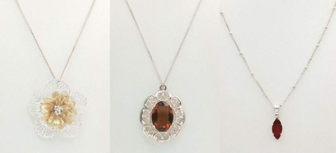 A Group of Three Sterling Silver Pendant Necklaces comprising a Filigree Flower