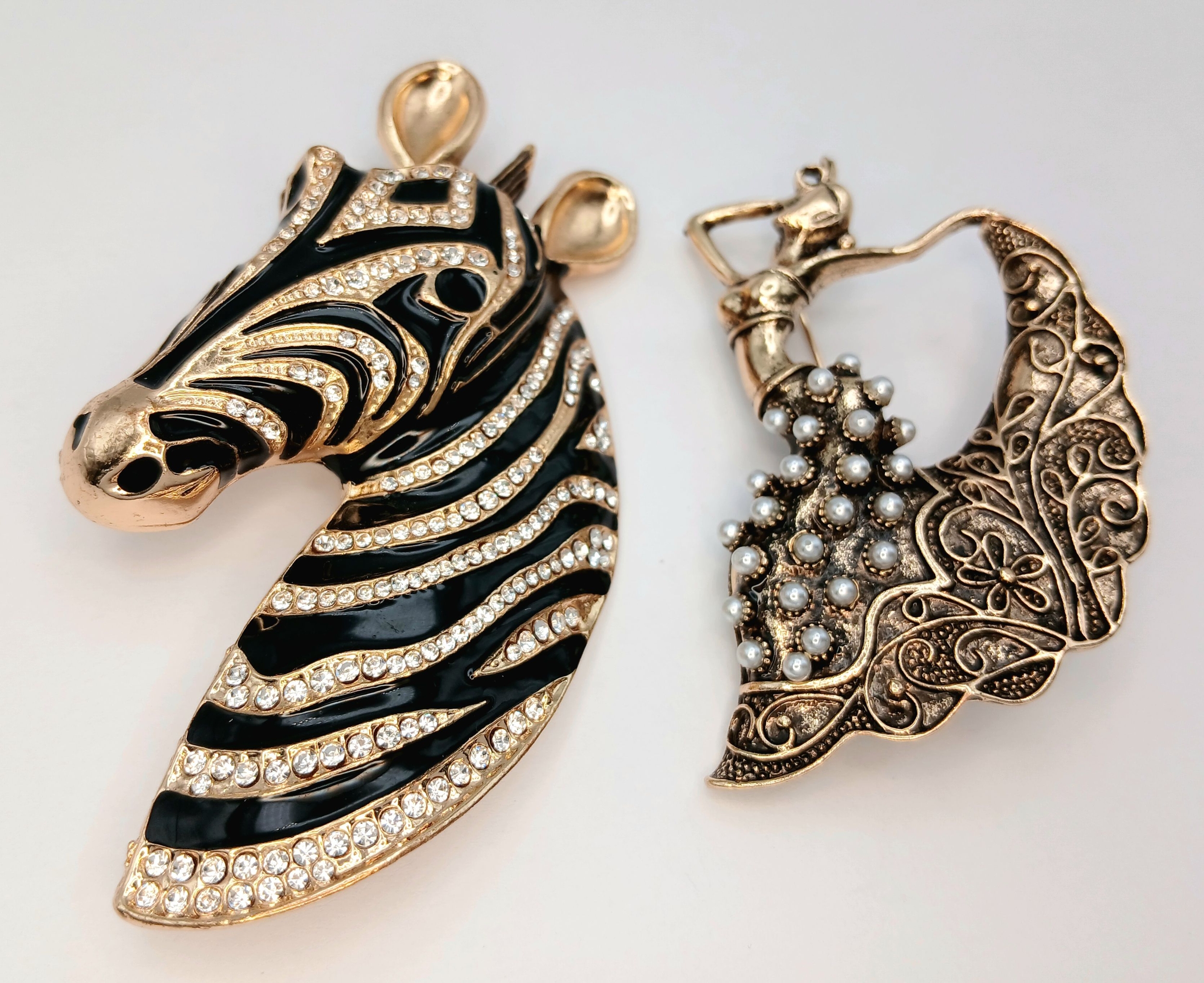 A Parcel of Two Decorative Gold Tone Brooches Comprising