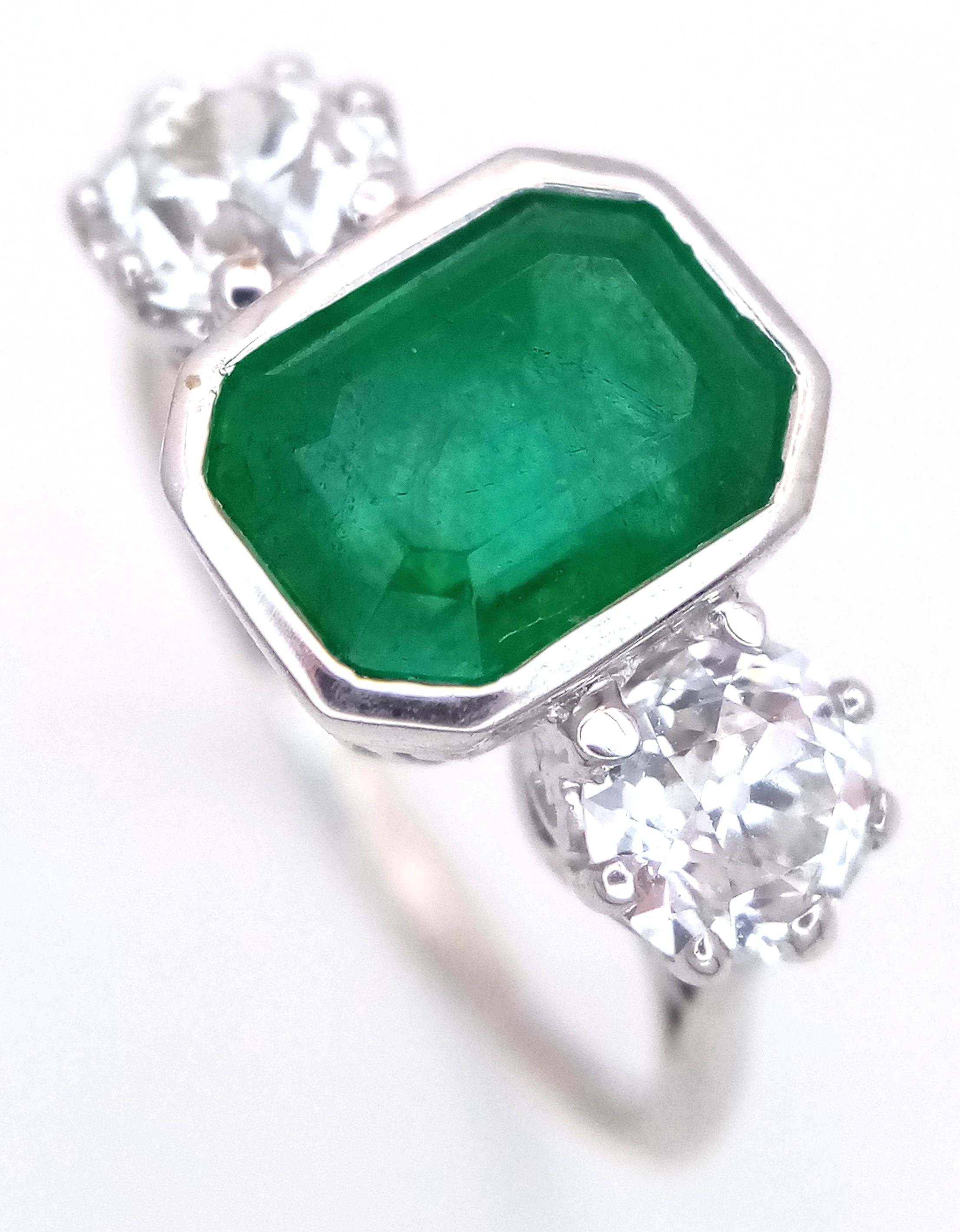 An Art Deco, W.G.I Certified, Platinum Emerald and Diamond Cocktail Ring