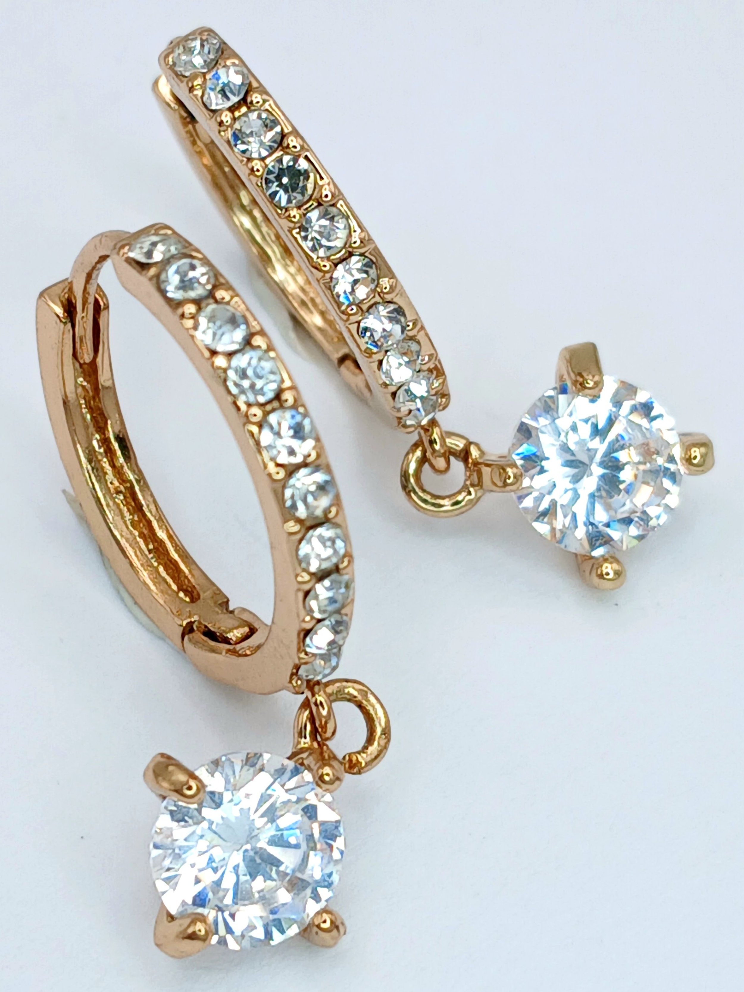 A PAIR OF GOLD PLATED EARRINGS WITH CZ STONES AROUND THE HOOP AND ONE LARGE DROP