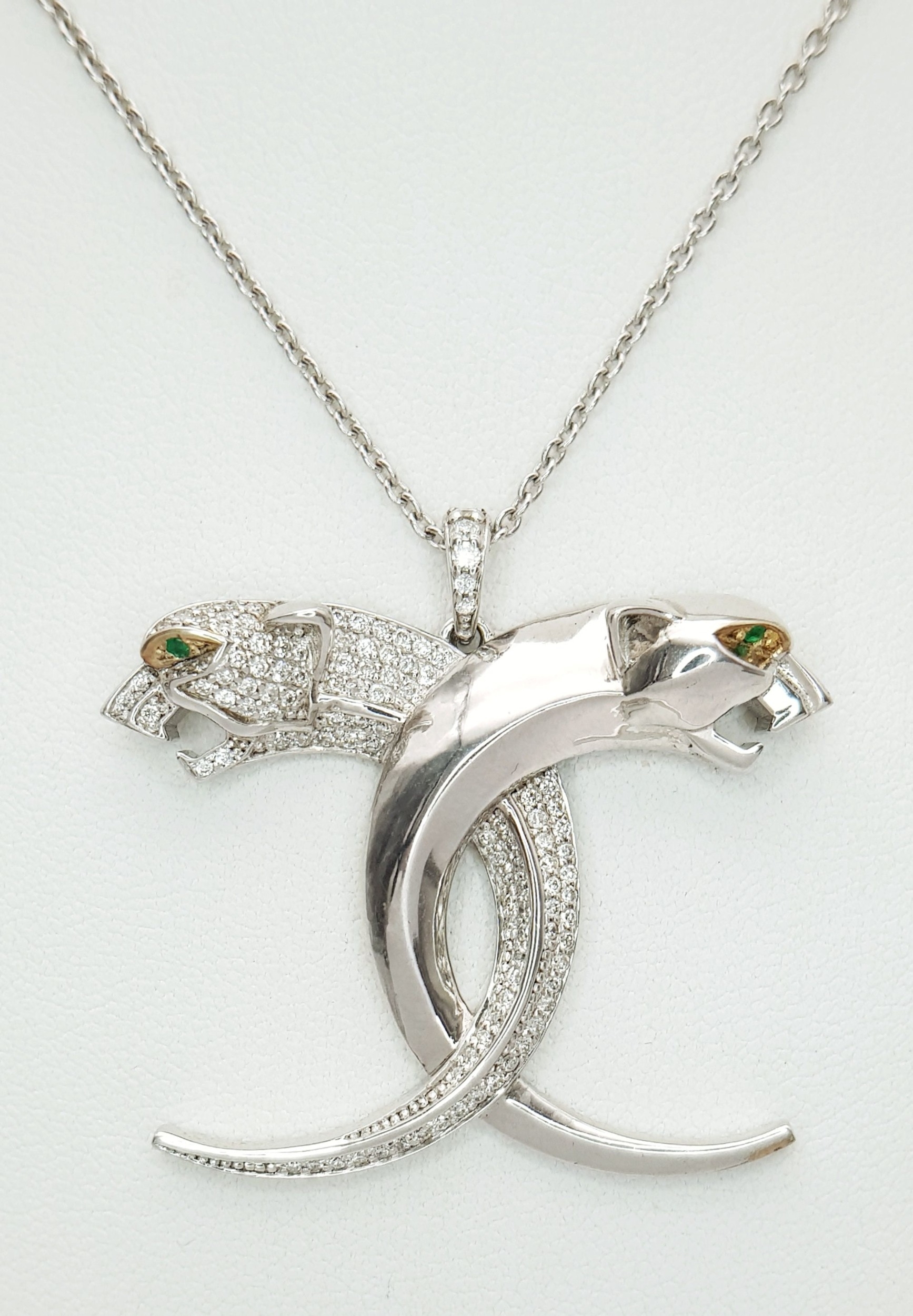An 18K White Gold and Diamond Crossover Twin Head Panther Pendant