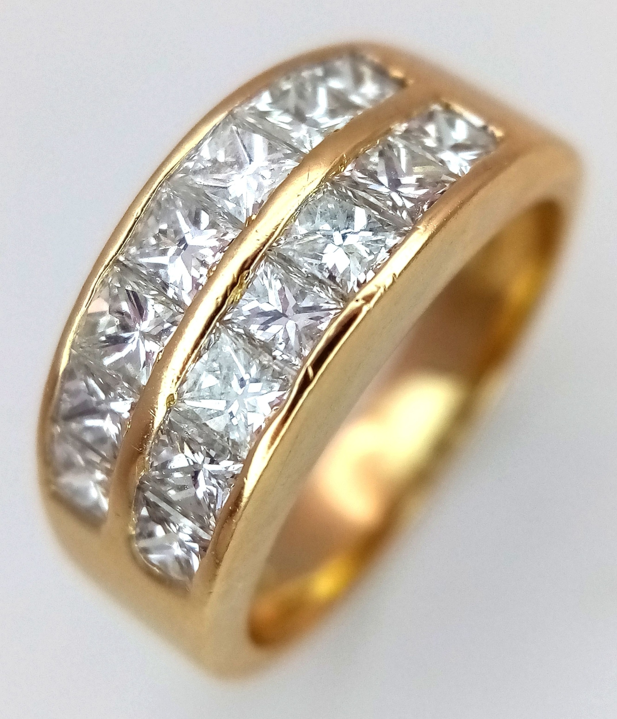 AN 18K YELLOW GOLD, 2 ROW, PRINCESS CUT DIAMOND SET BAND RING