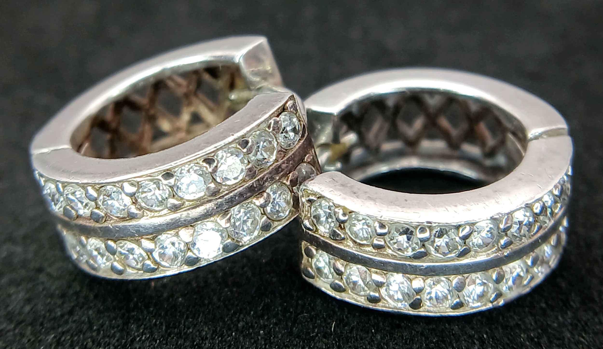 A PAIR OF STONE SET SILVER SMALL HOOP EARRIINGS . 4.5gms