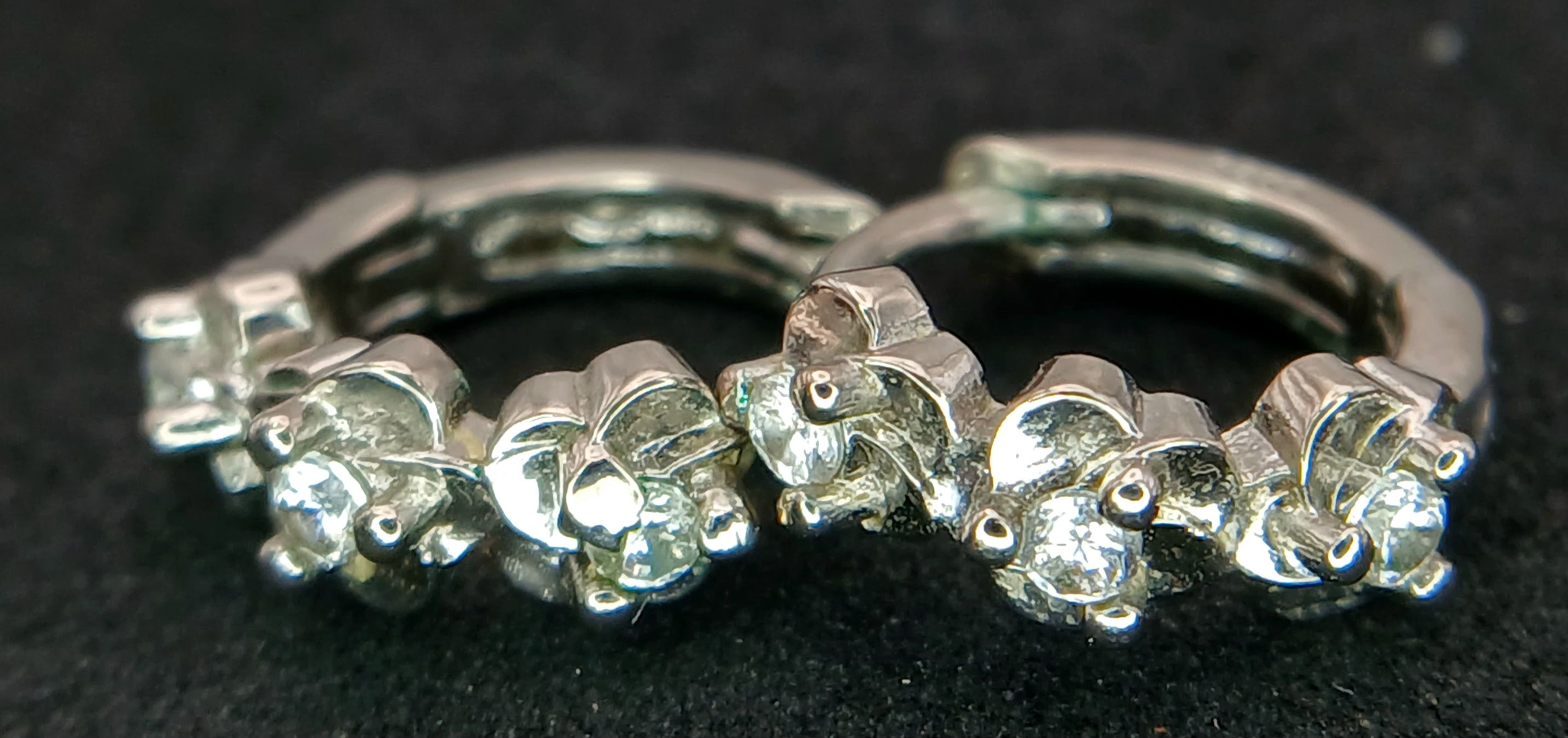 A PAIR OF STONE SET SMALL HOOP EARRINGS . 2.2gms