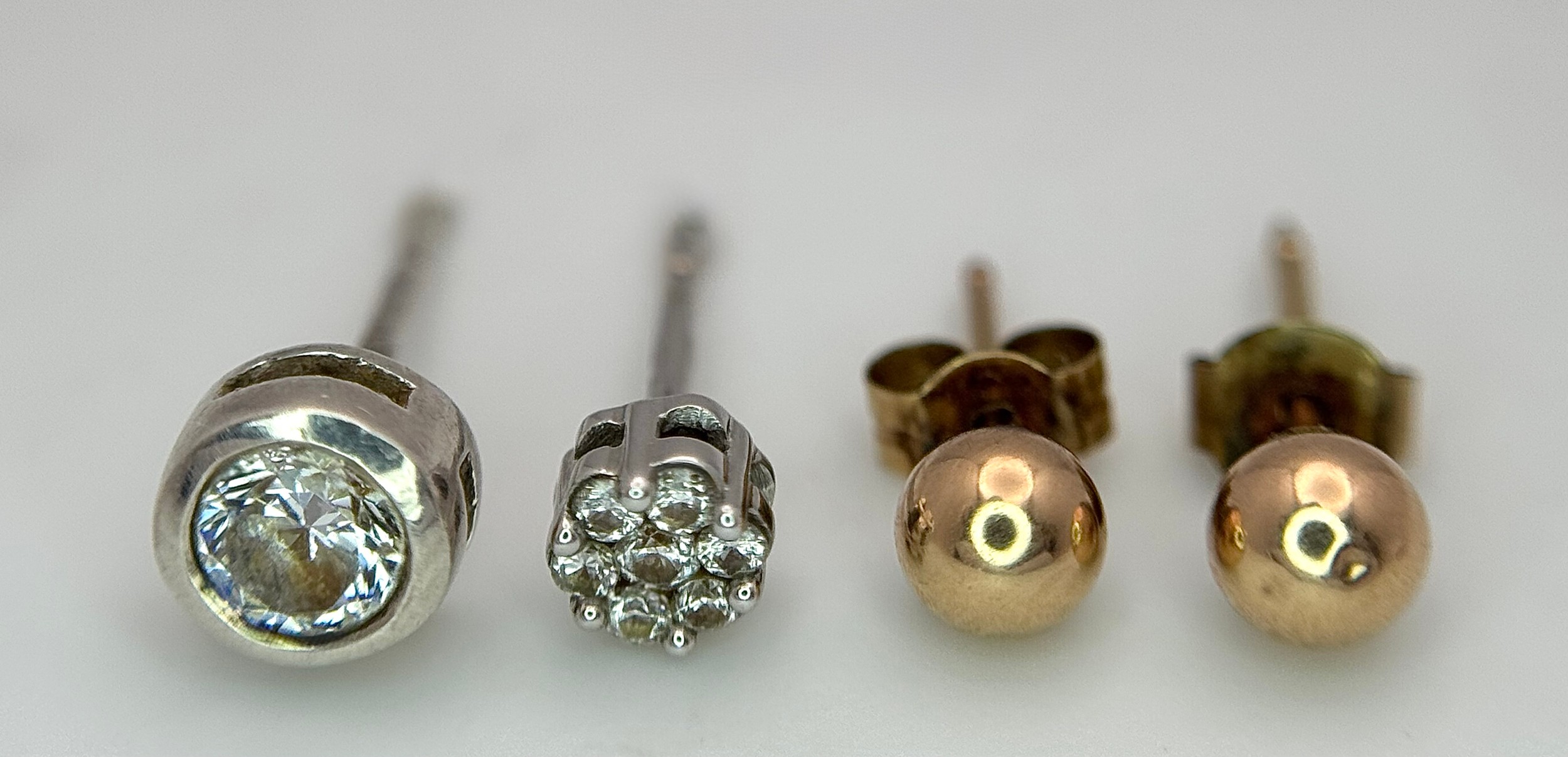 A Pair of 9K Yellow Gold Ball Stud Earrings PLUS One Diamond Stud and White