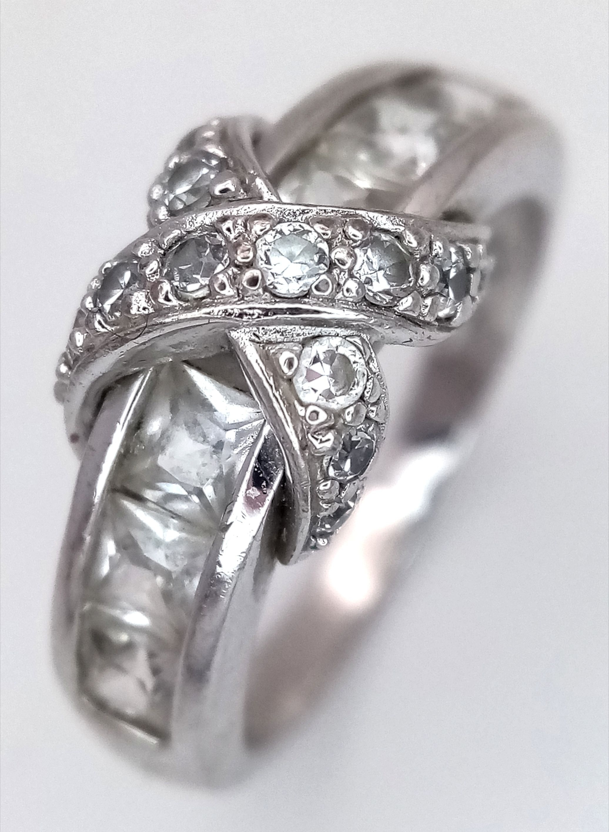 A STYLISH 925 SILVER RING WITH SPARKLING ZIRCONIA STONES . 4.2gms size O