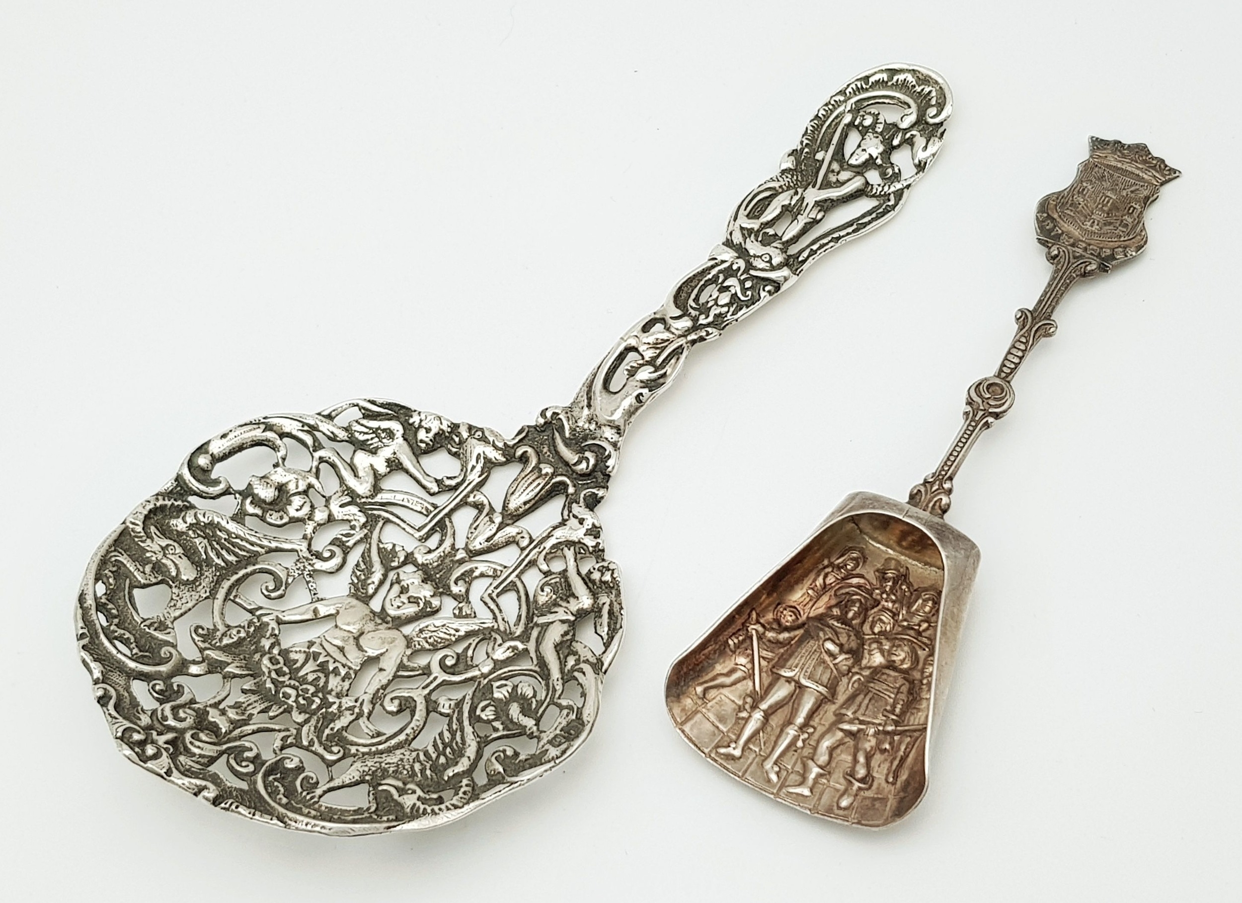 An antique silver spoon, hallmarked for Birmingham, depicting angels and cherubs