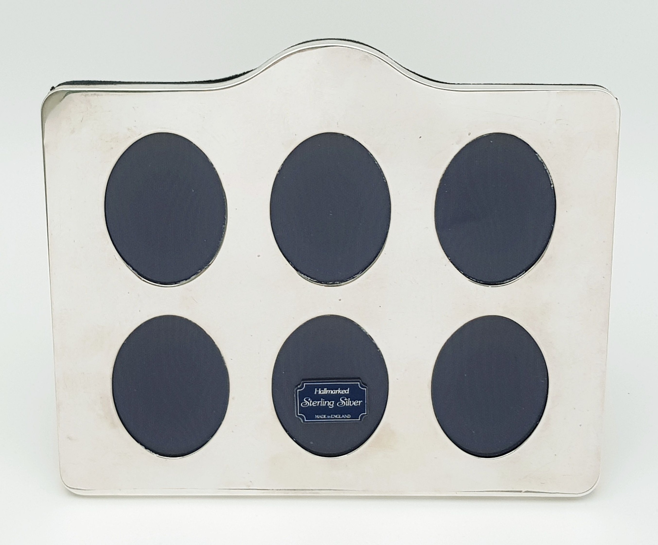A SILVER 6 PORT PHOTO FRAME . 16 X 21cms