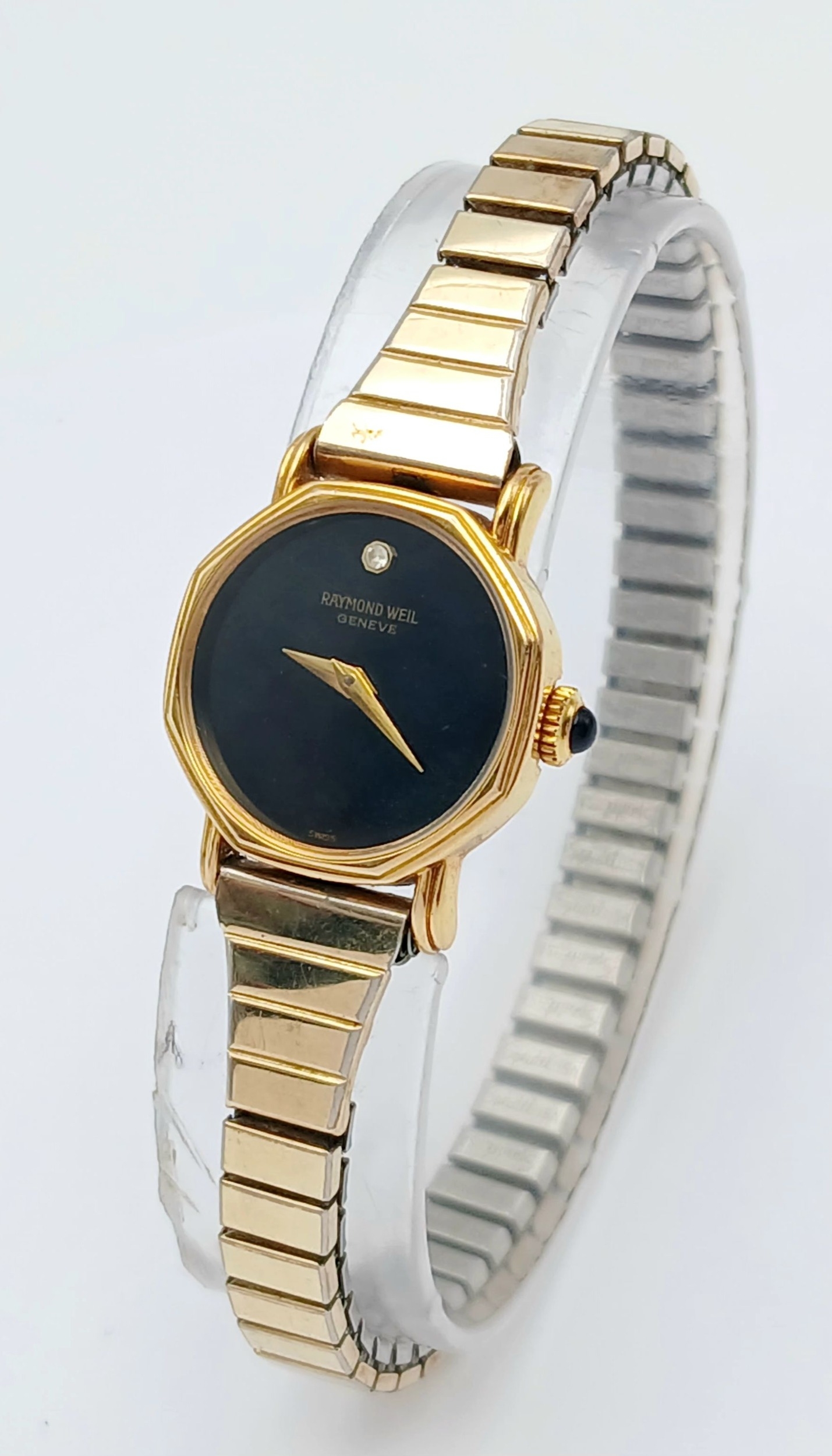 A RAYMOND WEIL, MANUAL WIND, GOLD TONE, STONE SET DIAL AND BUTTON