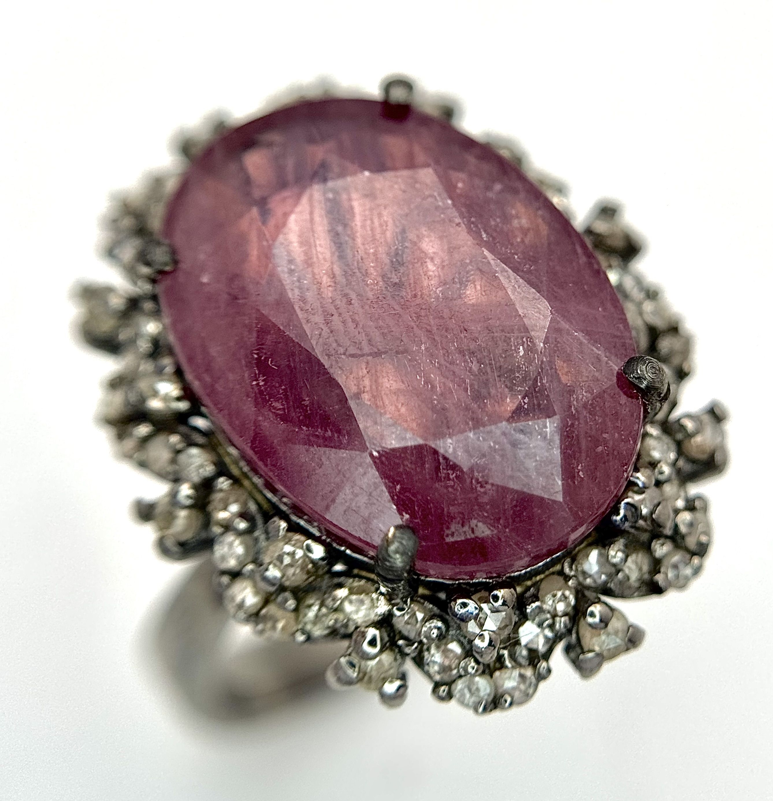 A 12ct Oval Cut Ruby Ring with 0.70ctw of Diamond Accents, set in 925 Silver