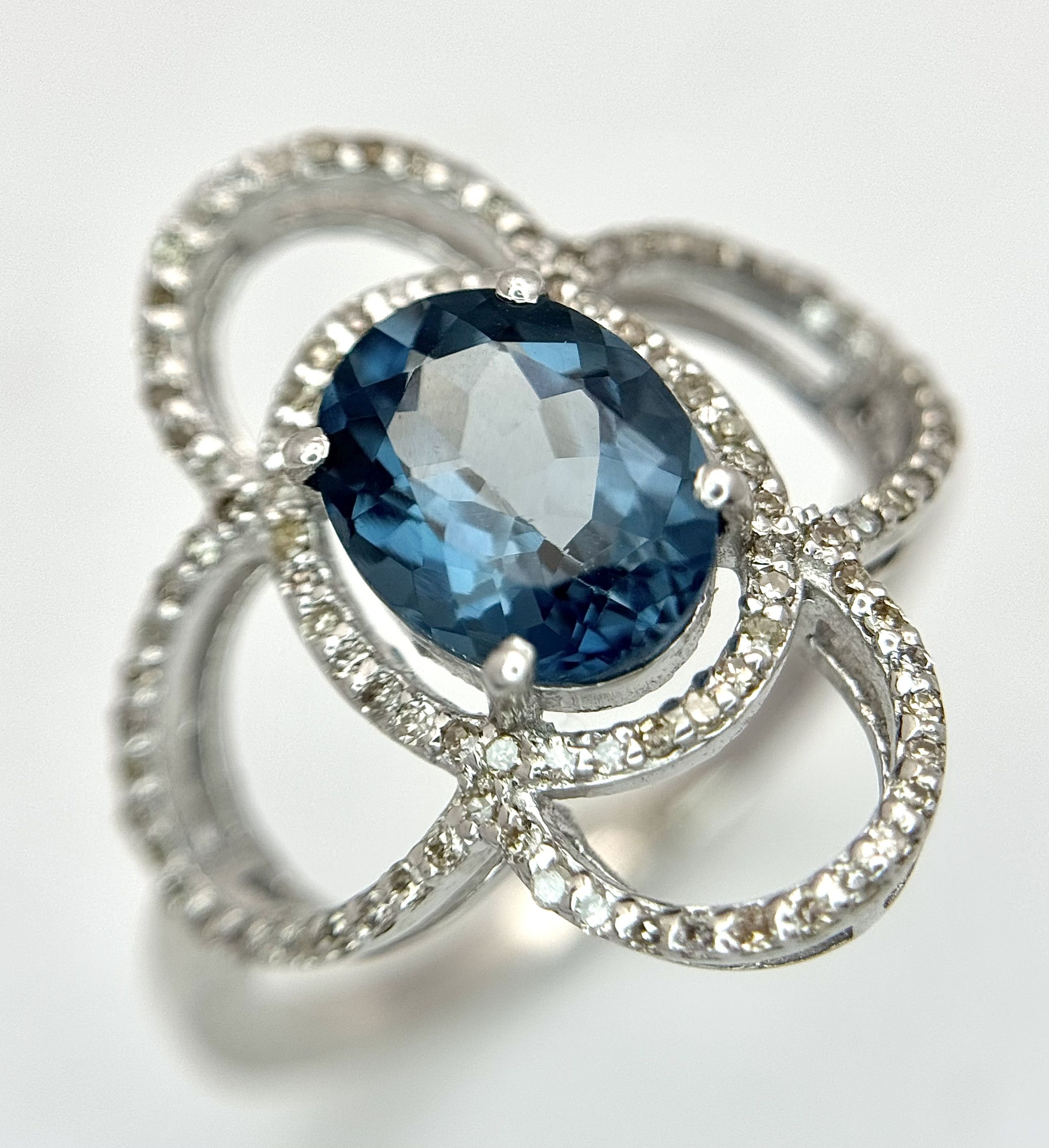 A Blue Topaz Ring set in 925 Silver with Diamond Accents