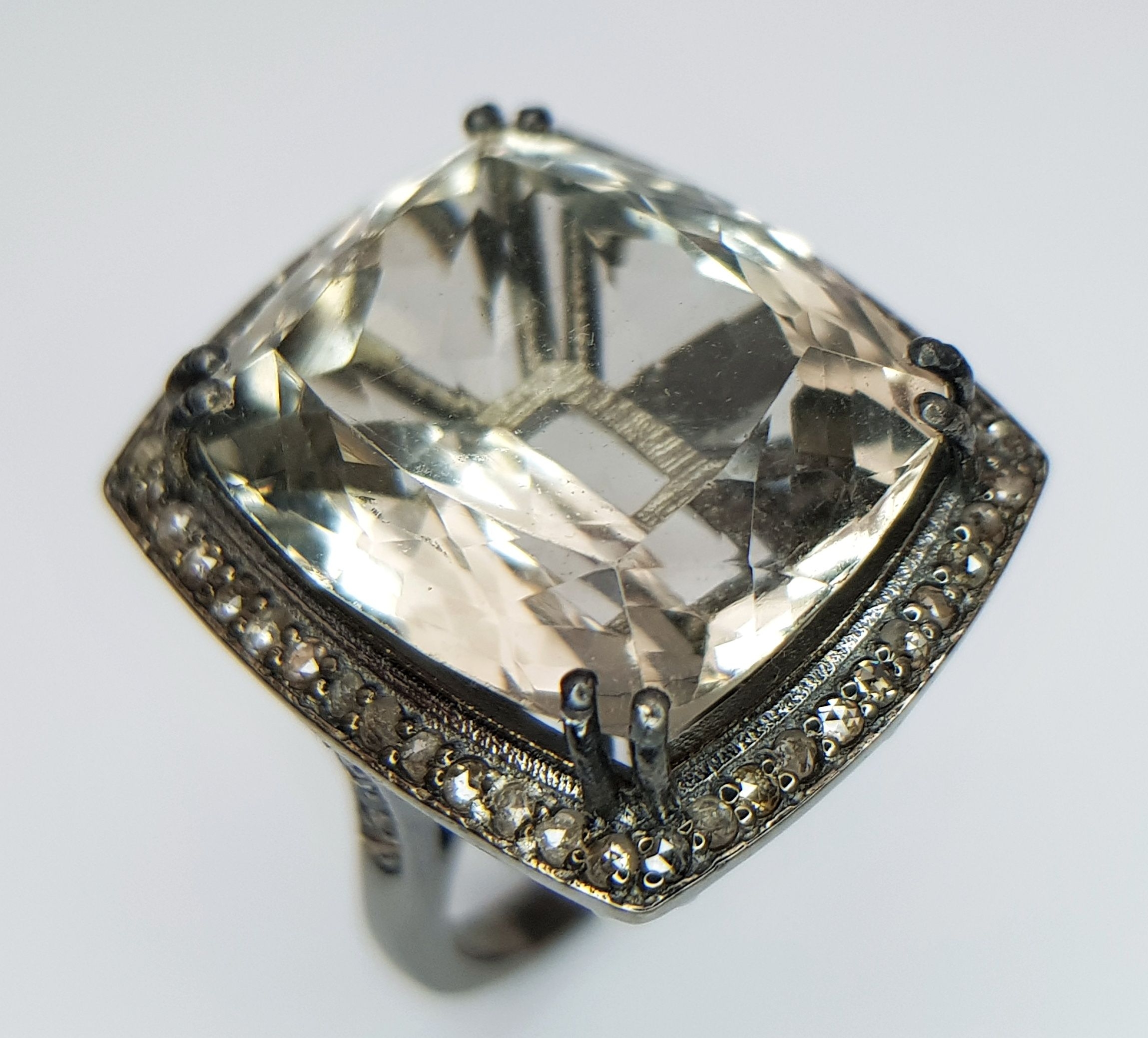 An 18ct Green Tinted Amethyst Ring with Diamond Surround set in 925 Silver