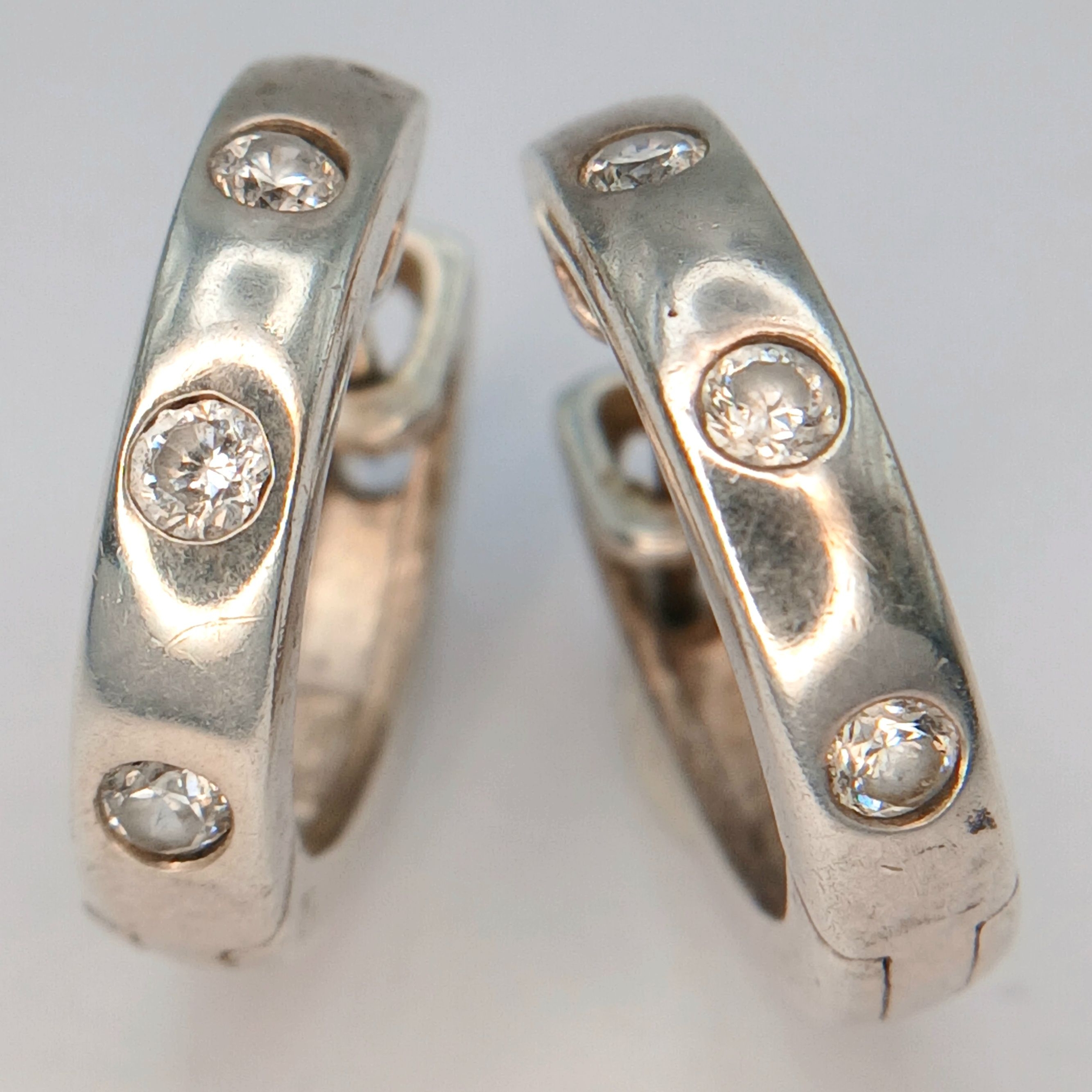 A 925 silver pair of CZ stone set hoop earrings