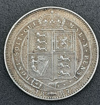 An 1887 Queen Victoria Silver Shilling Coin. VF+ grade but please see photos.