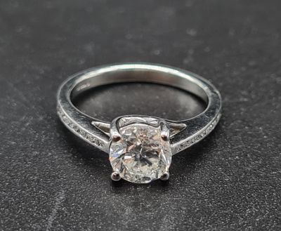 A Platinum Solitaire Diamond Ring with diamond shoulders. 3.82g. 1.02ct. Size I 1/2.