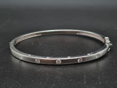 An 18K White Gold Diamond-Set Bangle. 17.2g. 0.4ct