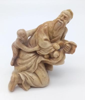 Antique Chinese soapstone of old man with monkey signed to the base in very good condition. 