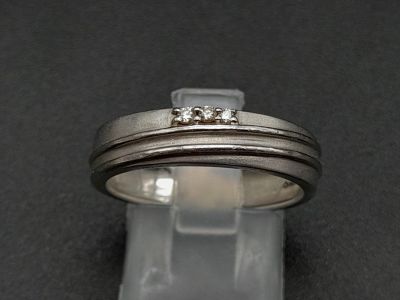 A 950 Platinum Diamond Band Ring. Three small diamonds. Size Q. 5.19g total weight. Ref - 190