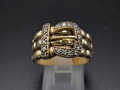 A 9K Yellow Gold and Diamond Buckle Ring. 18 diamonds .25ct complement this keeper piece. Size 