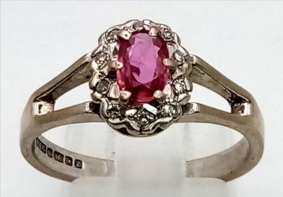 A Vintage 18K White Gold Natural Burmese Ruby and Diamond Ring. Central ruby surrounded with a 