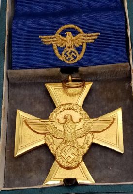 A German Reich's Police 25 Year Long Service Medal. This is a gilt cross depicting the German 