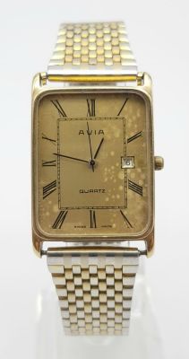 A Vintage Avia 9K Gold Cased Watch. Gilded strap. Gold rectangular case - 33 x 23mm. Dial is 