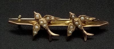 A Victorian Mid-Karat Gold Swallow and Pearl Bar Brooch. Pin has been replaced. 4cm. 1.4g total 