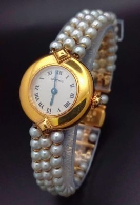 A very feminine CARTIER COLISEE watch. 18 K yellow gold, with a quality genuine pearl strap and 