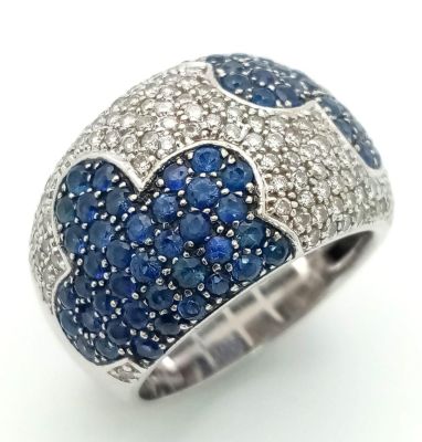 An 18K White Gold Sapphire ad Diamond Cluster Ring. Mirror image sapphire clouds in a diamond 