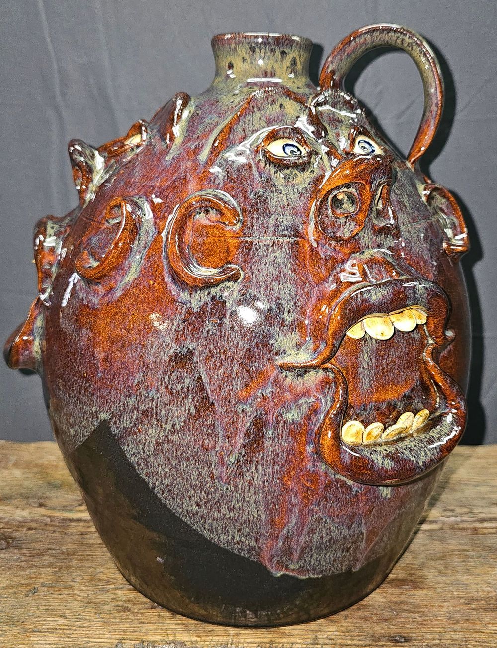 Lot 162: Stunning Roger Corn Multi-Face, Face Jug
