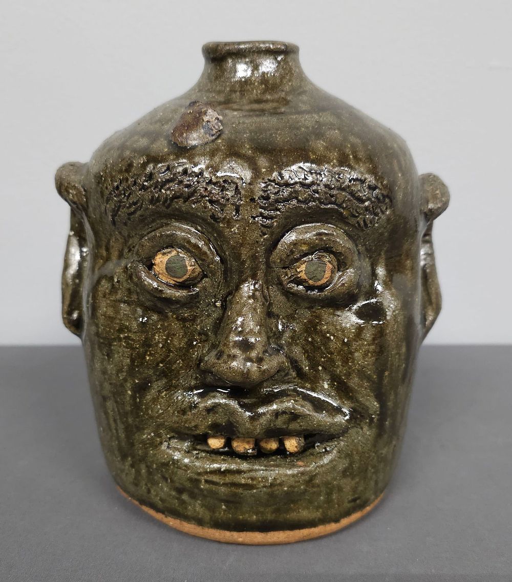 Lot 142: Early Reggie Meaders Face Jug