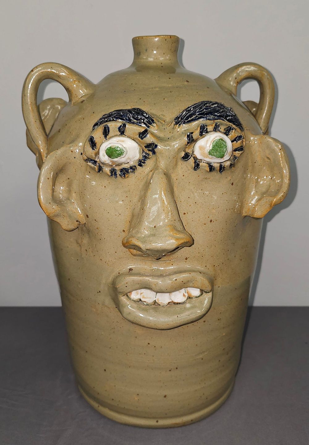 Lot 198: Monumental Jerry Brown Seven Gallon Double Sided Face Jug