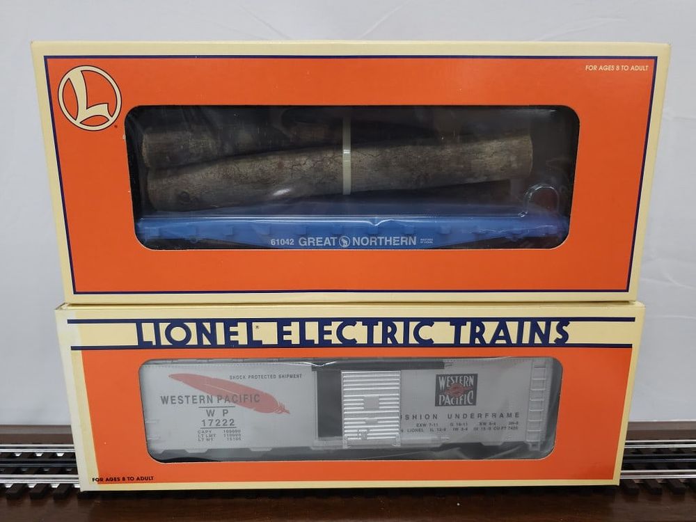 Lot 149: Lionel Boxcar and Log Car Lot of Two (NIB)