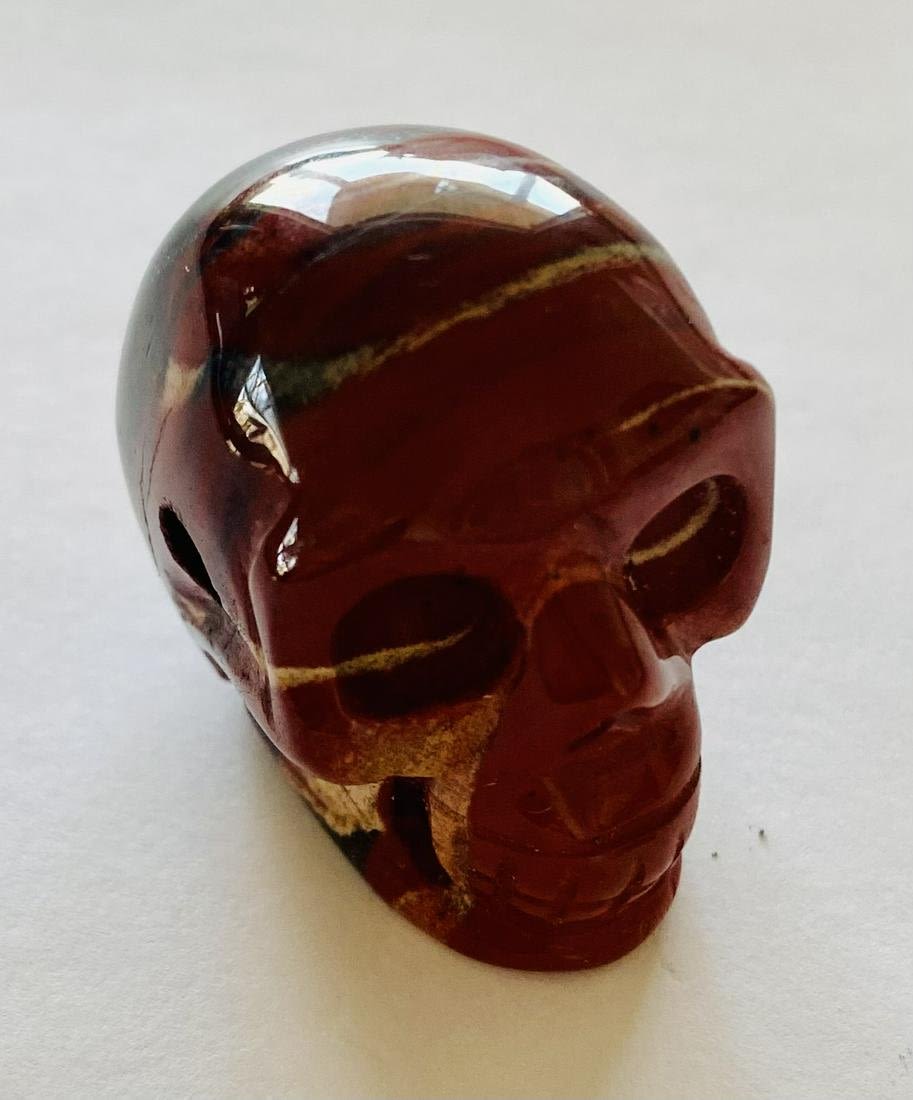 Lot 174: Carved jasper skull drilled