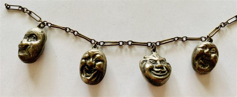 Lot 196: 4 character faces on both sides charms