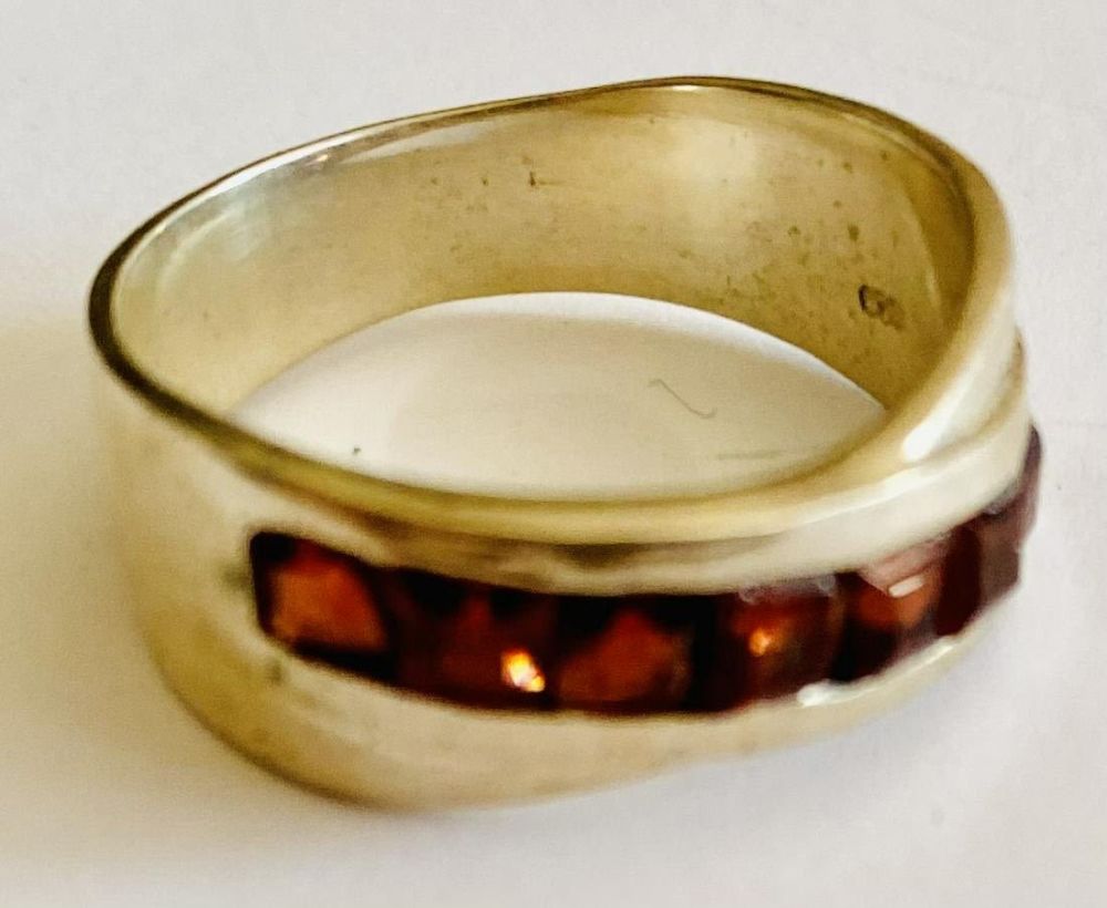 Lot 207: Sterling garnet ring band