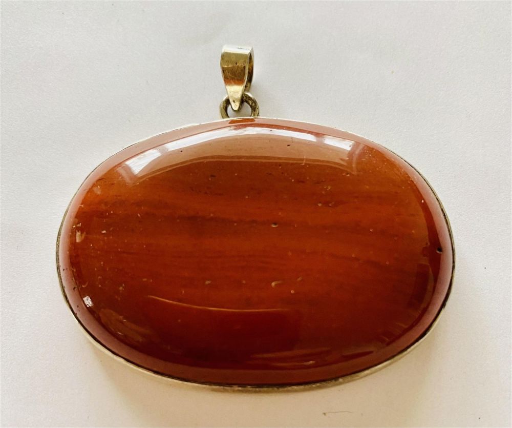 Lot 212: Large brown cabochon gemstone sterling pendant