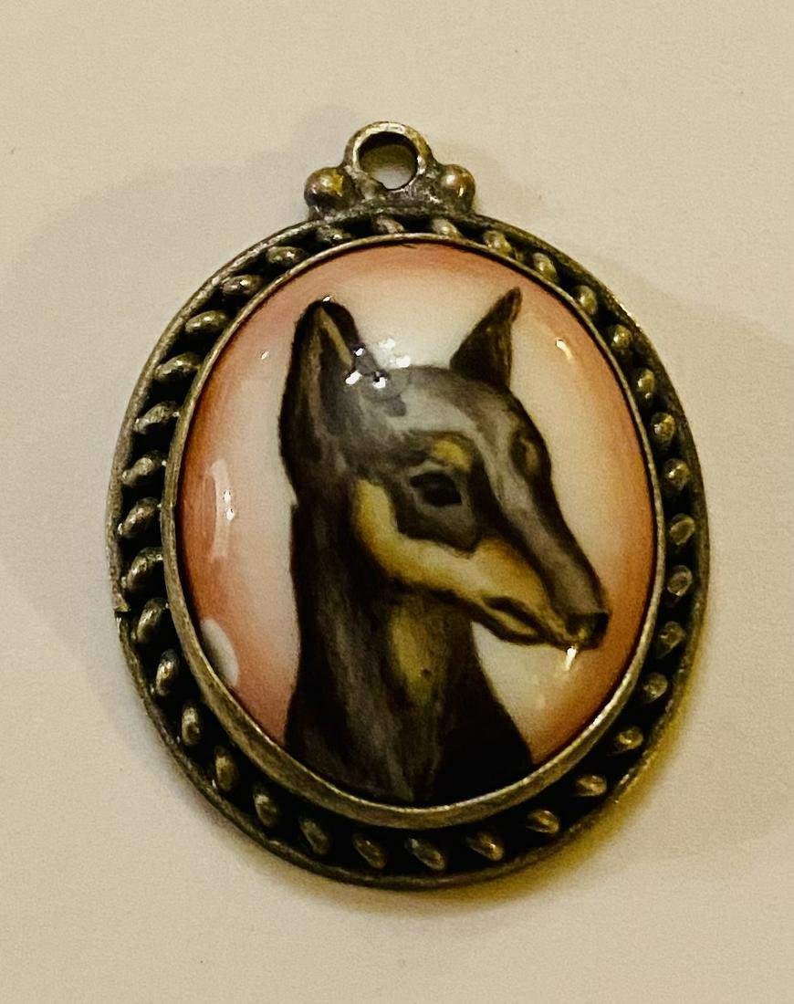 Lot 222: Russian hand painted dog filigree pendant