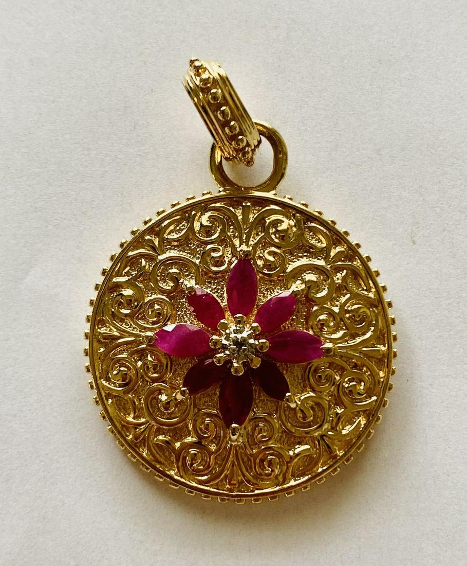 Lot 254: Ruby vermeil pendant/ charm