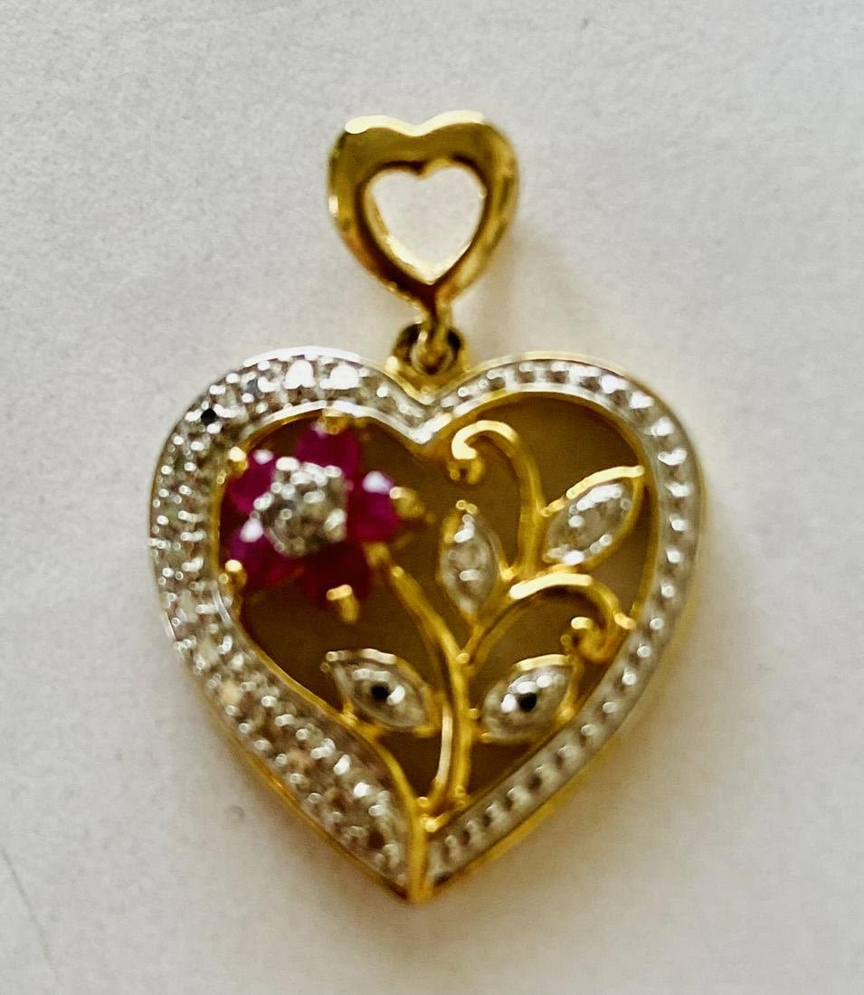 Lot 255: Vermeil heart ruby flower pendant