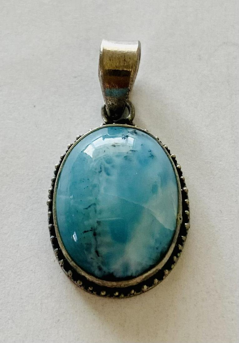 Lot 260: Oval cabochon larimar pendant