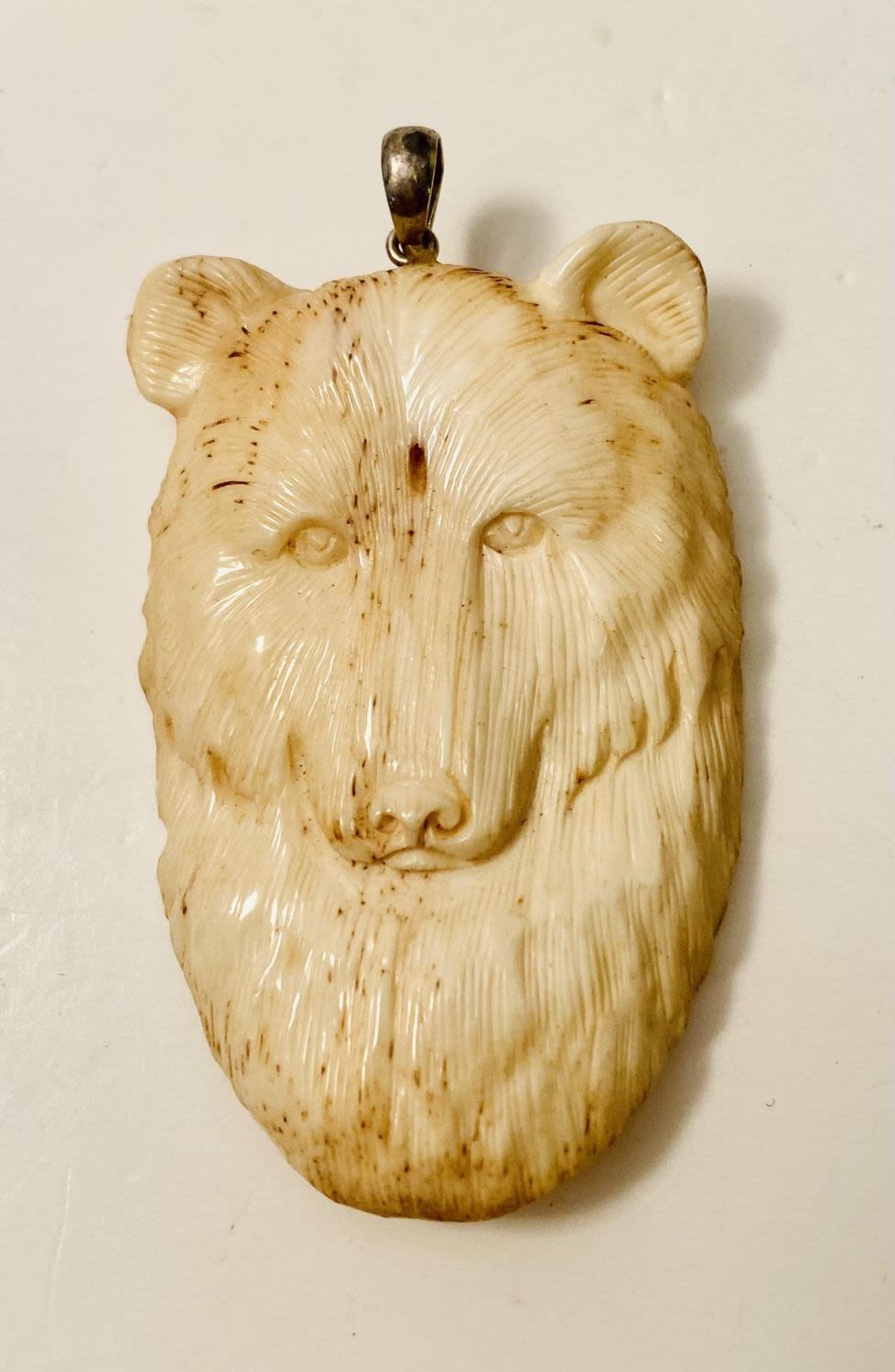 Lot 197: Carved bone bear pendant
