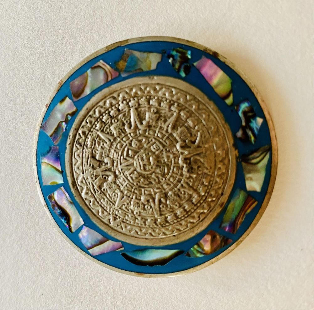 Lot 292: Antique round pin pendant Aztec design