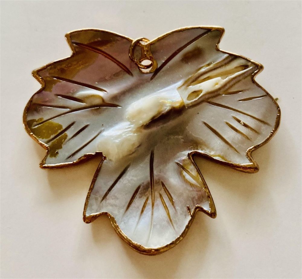 Lot 346: Mother of pearl seashell carved into leaf/gold rim pendant