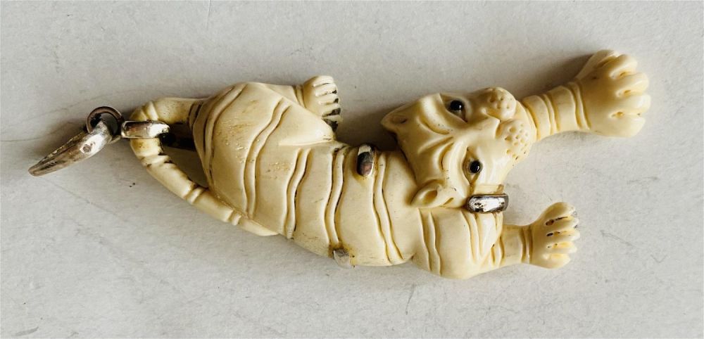 Lot 493: Carved tiger sterling pendant