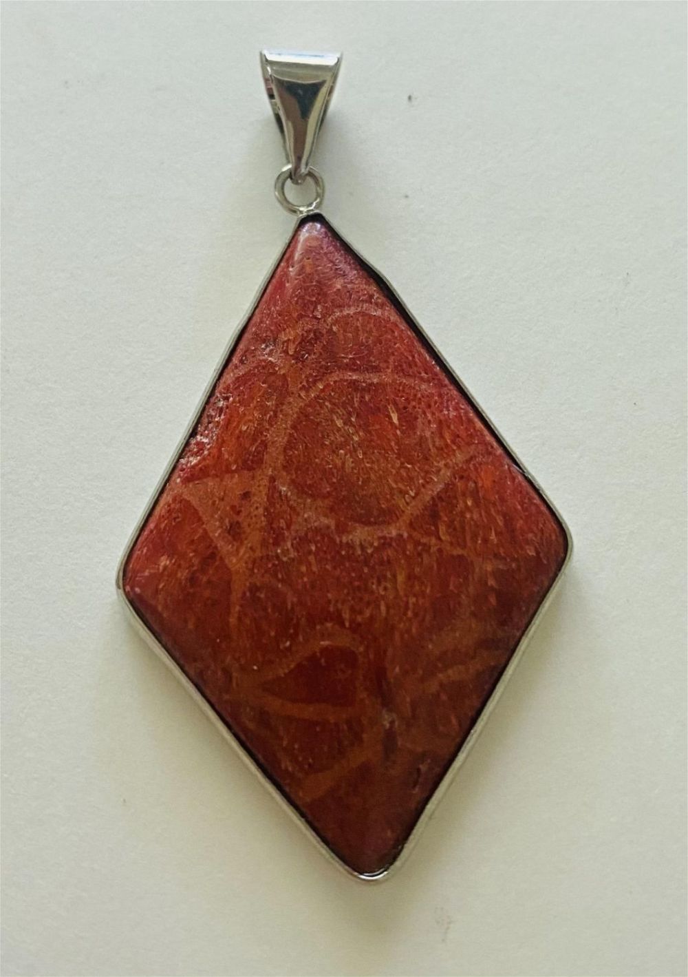 Lot 157: Coral diamond shape pendant