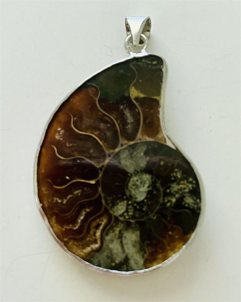 Lot 235: Sterling ammonite pendant fossil