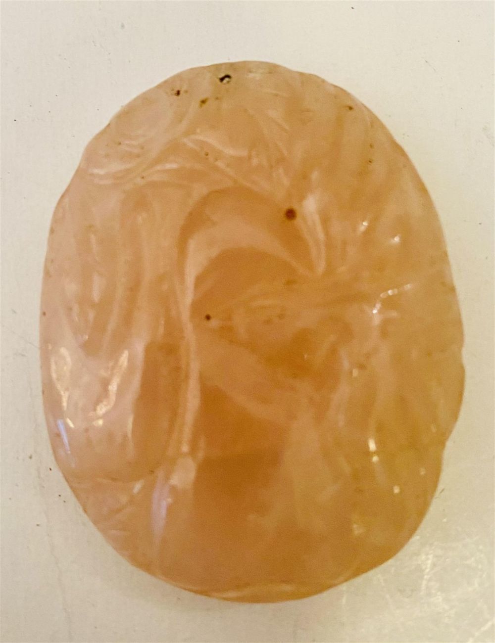 Lot 447: Rose quartz hand carved oval plaque