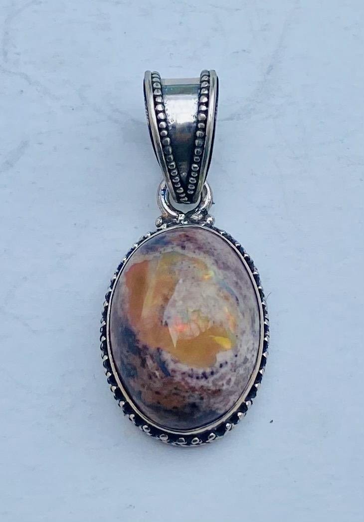 Lot 166: Opal cabochon sterling pendant