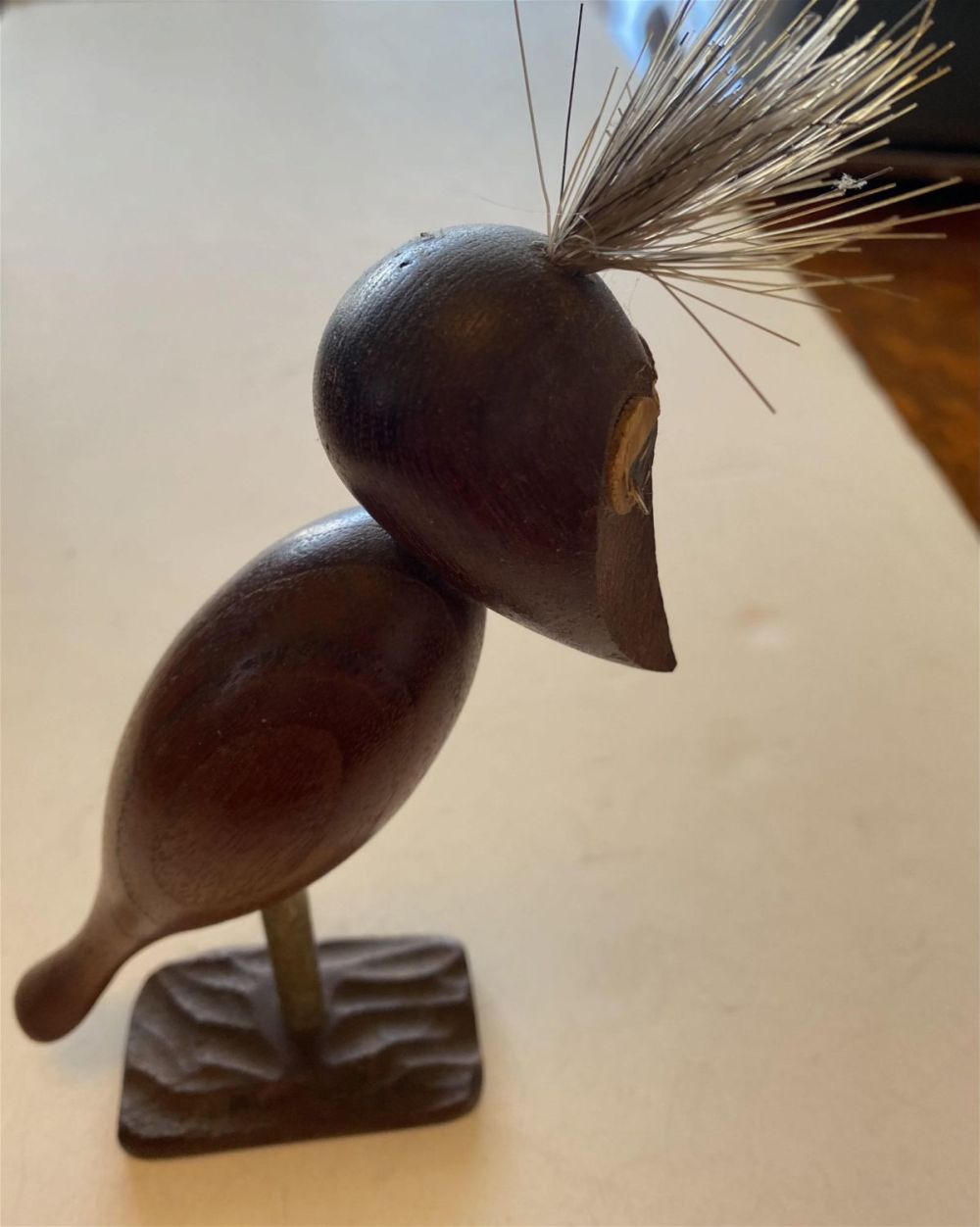 Lot 194: Carved antique wood bird on stand with brush hair